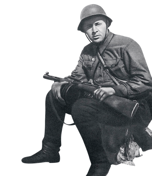 Фотография военного, который сидит с пулеметом в руках